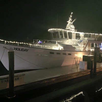 Captain Mark's boat lit up at night in Hilton Head