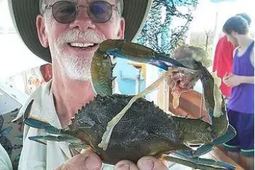 Man showing crab he caught in Hilton Head